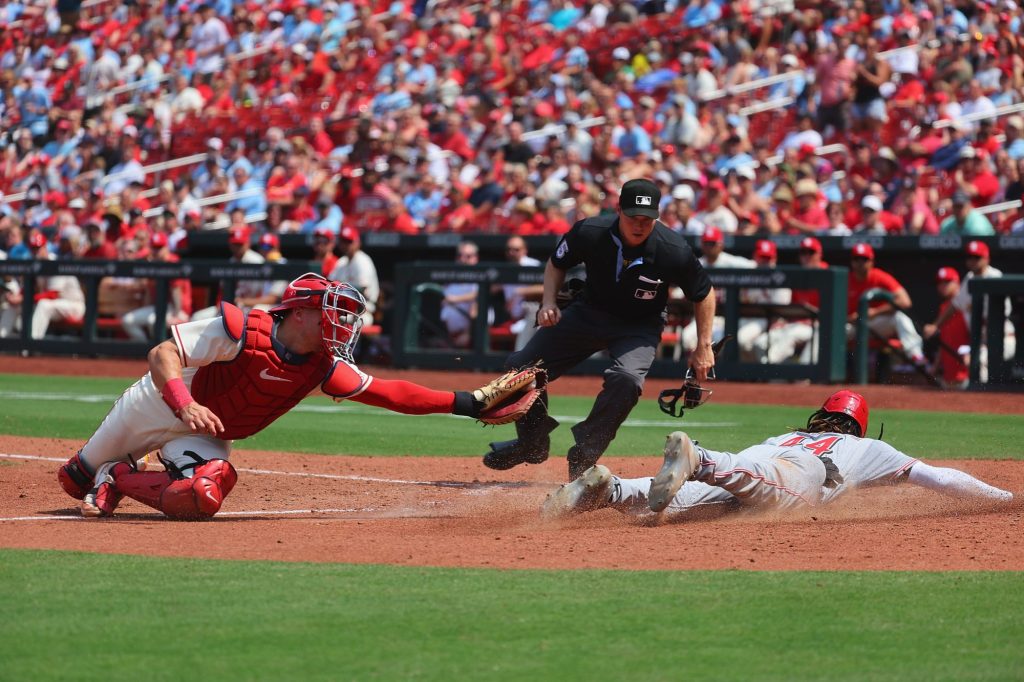 Elly De La Cruz (44) of the Cincinnati Reds scores a run against Andrew Knizner (7) of the St. Louis Cardinals in the seventh inning at Busch Stadium on June 10, 2023 in St Louis, Missouri.