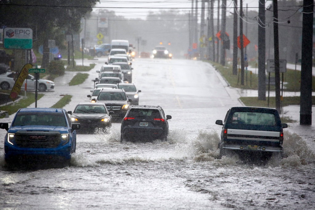 Cars navigate through flooding in Palm Harbor, Florida, as thunderstorms spawned by Tropical Storm Arlene move through the area on June 2, 2023.